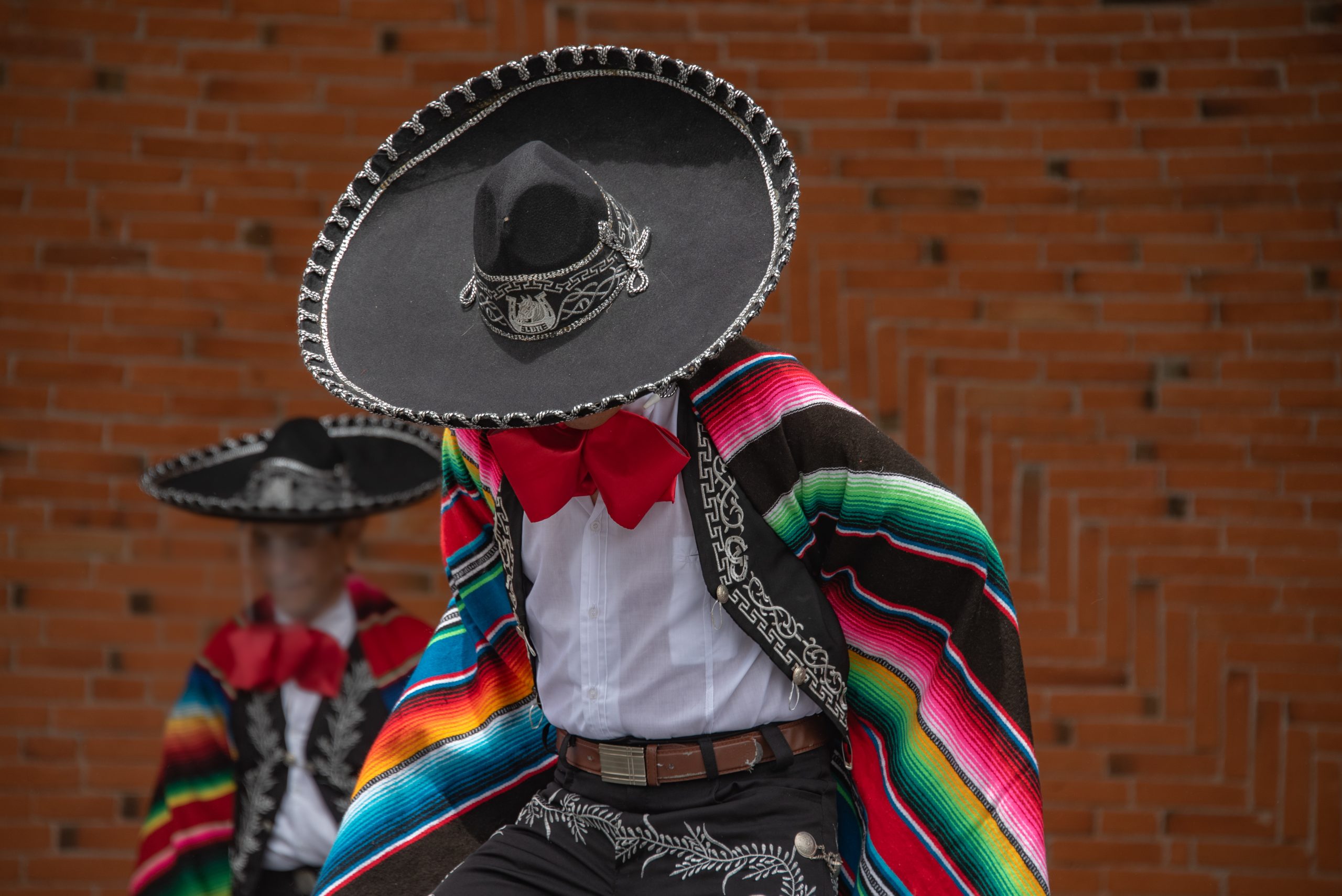 Mexican charro dancer from Jalisco Mexico with a multicolored striped serape and large hat with silver decorations Mexican charro dancer from Jalisco Mexico with a multicolored striped serape and large hat with silver decorations