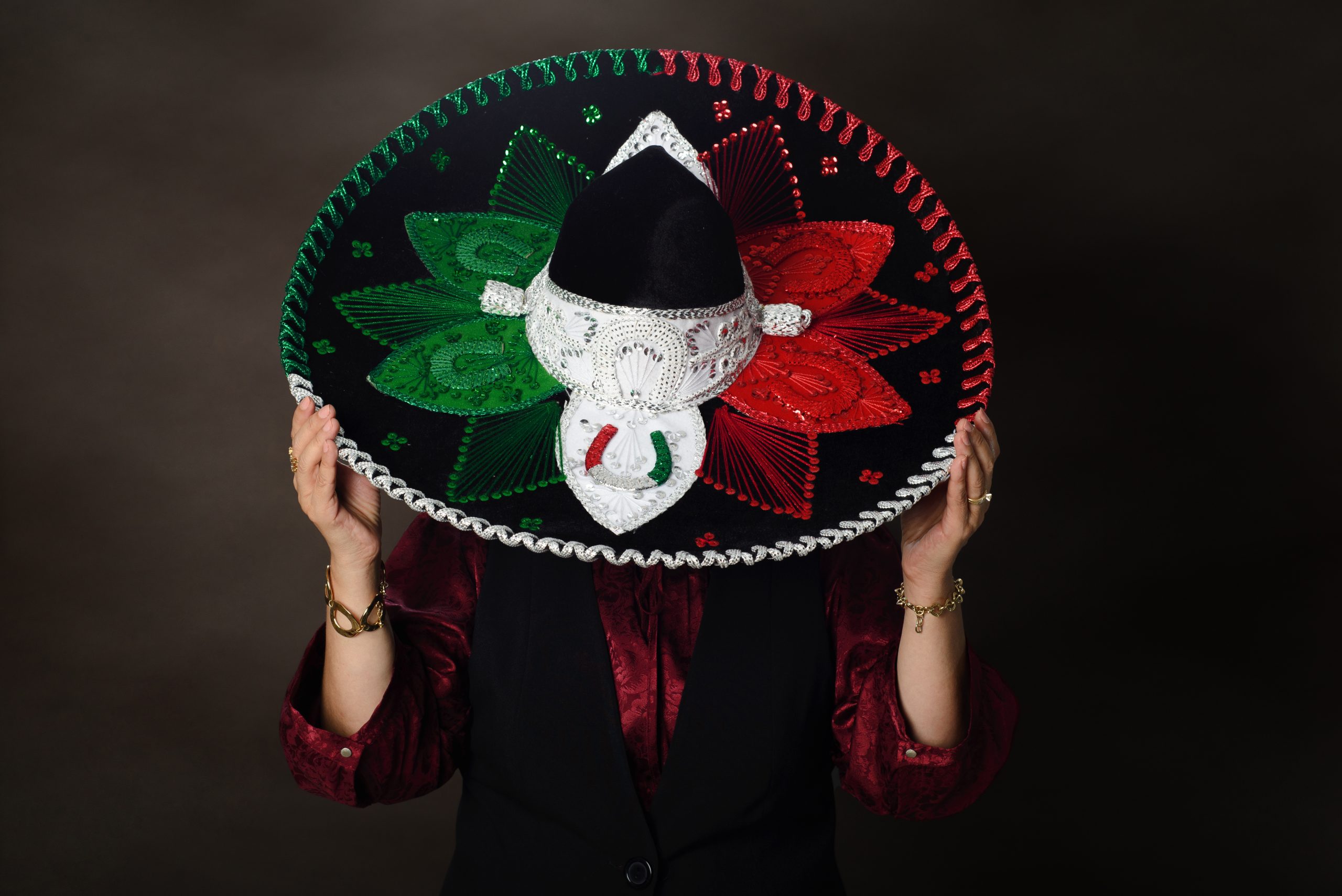 Studio portrait of person wearing charro hat. Studio portrait of person wearing charro hat. Typical Mexican hat with colors of the flag.